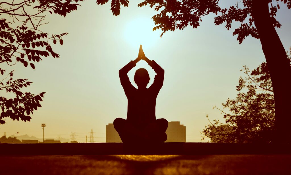 Balanced And Peaceful Morning With Sunrise doing meditation / yoga